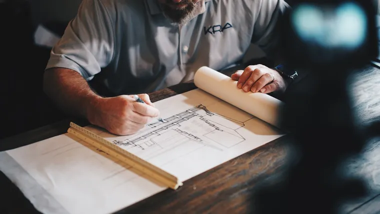 Building professional reviewing residential construction drawings