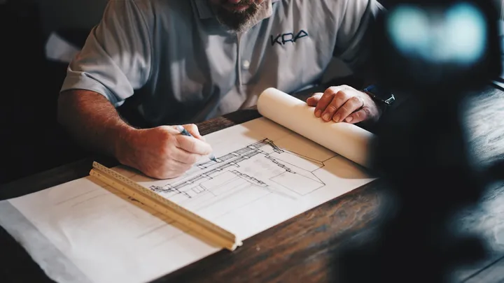 Building professional reviewing residential construction drawings