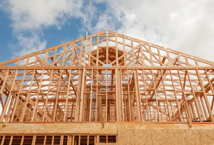 New home framing under construction before performance details are completed